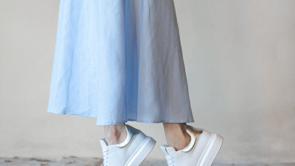 A blue summer dress and white leather orthopedic sneakers.