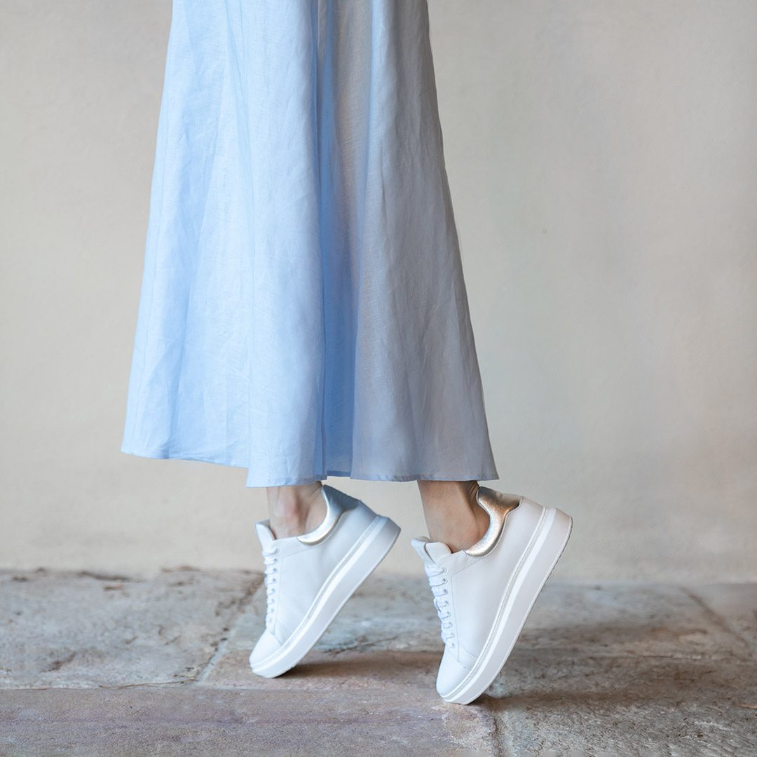 A blue summer dress and white leather orthopedic sneakers.